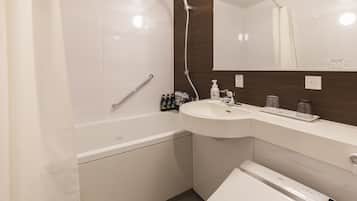 A modern bathroom with a bathtub, a sink, and a mirror.
