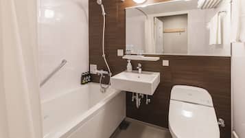 Un baño moderno con bañera, lavamanos e inodoro.