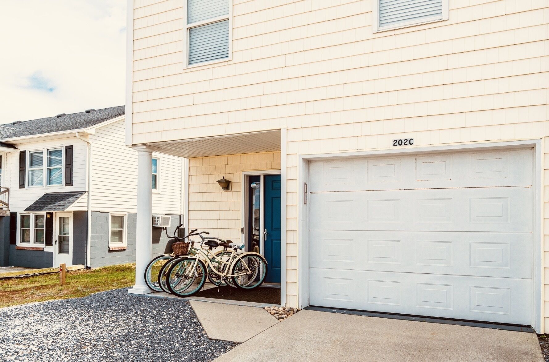 A two-story house with a garage door marked "2020".