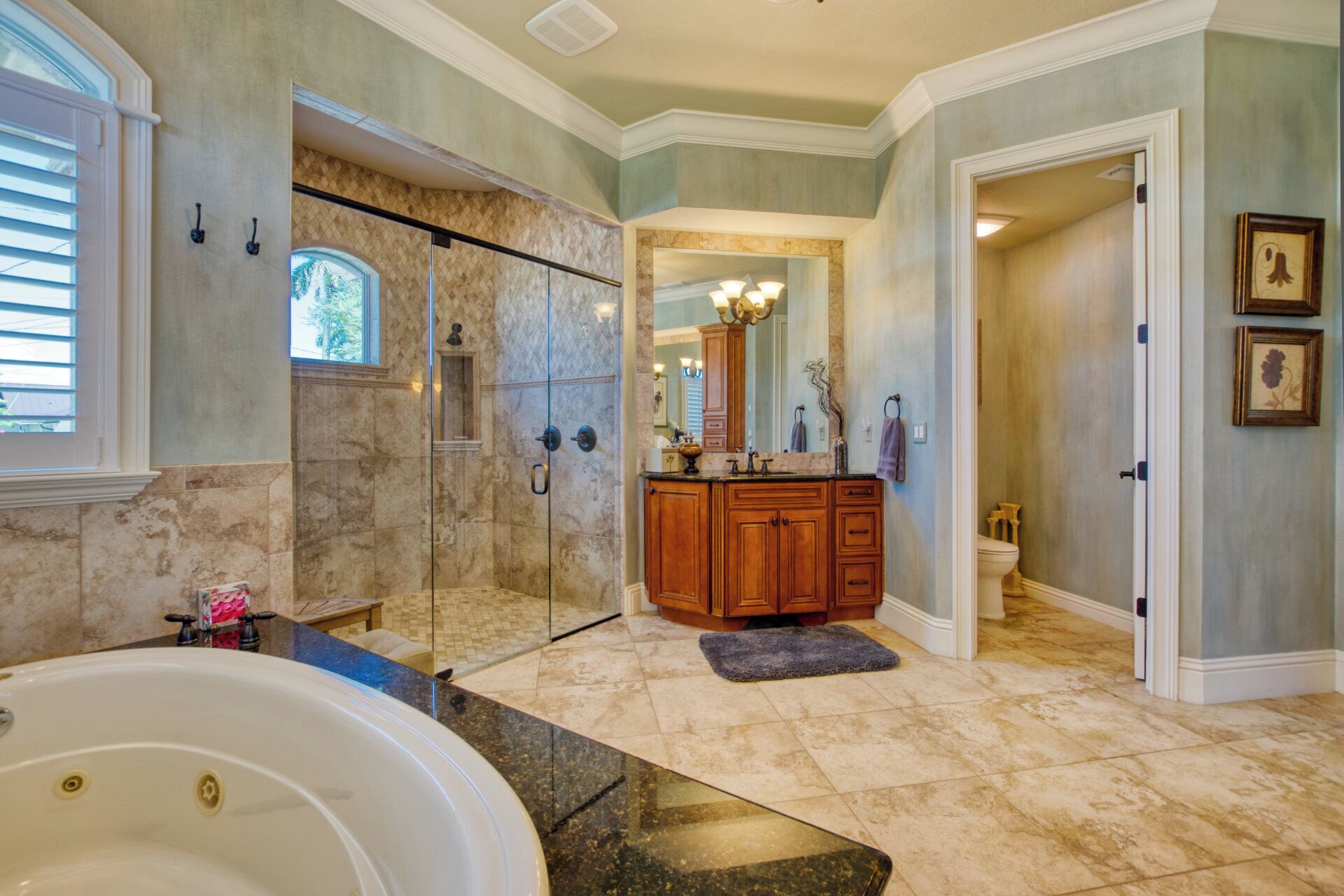A spacious bathroom with a large bathtub, a walk-in shower, and a vanity with a mirror and sink.