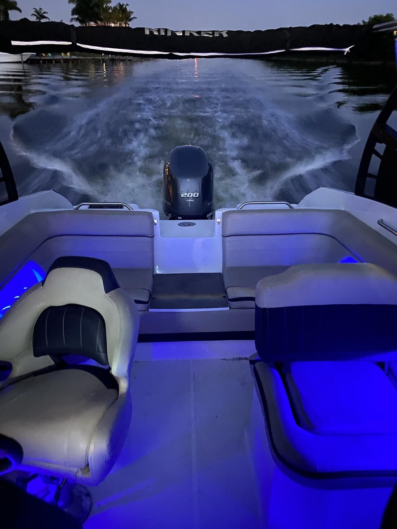 A boat with a 200 horsepower motor, equipped with two seats and a central console.