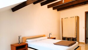 A bedroom with a wooden bed, a nightstand, a desk, and a wardrobe. - Gite for 15 people Le Canebal right, wifi heated pool to share (Sarlat-la-Canéda)
