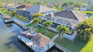A residential area with houses, a dock, and a boat.