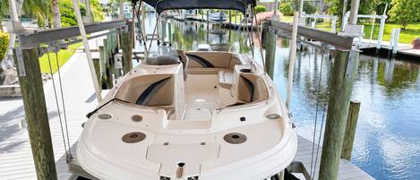 A boat docked at a pier with a covered walkway overhead.