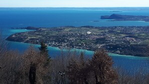 A coastal town with a view of the sea and a prominent hill in the distance.