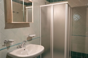 Shower, hair dryer, towels, toilet paper