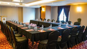 A conference room with long tables, chairs, water bottles, and nameplates. - Melid Hotel (Malatya)