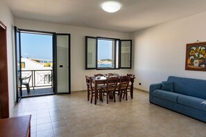 Family Apartment | Living area | 30-inch flat-screen TV with cable channels, TV