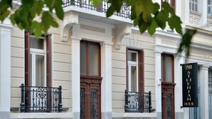 A historic building with ornate iron balconies and classic architectural details. - 1900 Athenian House (Athens)