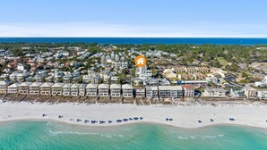 An aerial view of a coastal town with beachfront properties, a marina, and a clear blue sky. - 🏖Steps 2 Beach Access🏴‍☠️Pirate Themed🏝️Private Pool/Luxury/Location (Miramar Beach)