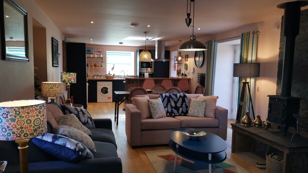 A cozy living room with a sofa, a coffee table, and a fireplace.