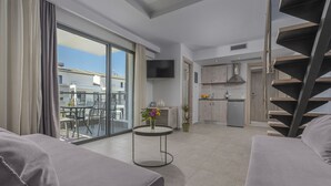 A modern apartment with a balcony, a kitchen, and a staircase. - Adonis Luxury Village (Kassandra)