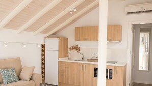 A modern kitchen with wooden cabinets, a built-in dishwasher, and a countertop with a sink.