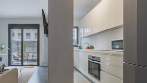A modern kitchen with a built-in oven and a microwave.