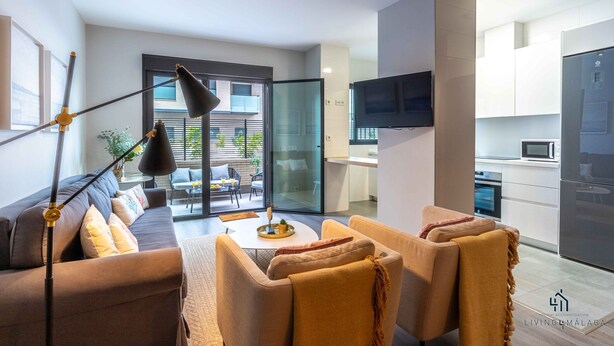 A modern living room with a sofa and armchairs, a coffee table, and a floor lamp.
