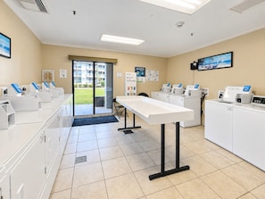 A clean, well-lit room with a reception desk, a computer station, and a view of a building outside.