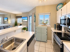A modern kitchen with a dishwasher, a microwave, and a stove.