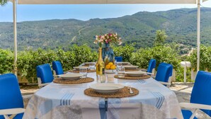 A table set for dining with a scenic mountain view in the background. - Villa Ottagonale, Capo Perla (Capoliveri)