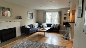 A living room with a fireplace, two sofas, a coffee table, and a patterned rug. - Spacious and comfortable 5 bed, hot tub, home theater, fireplaces (Boulder)