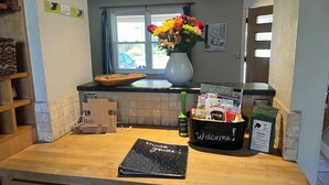 A kitchen counter with a vase of flowers, a welcome sign, and a bag of coffee. - 5 Bed/4BA Spacious comfy w/Hot tub, Home Theater, 5 min to CU and all Sundance (Boulder)