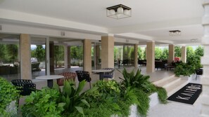Relax in our serene outdoor seating area surrounded by lush greenery and beautifully maintained gardens.
