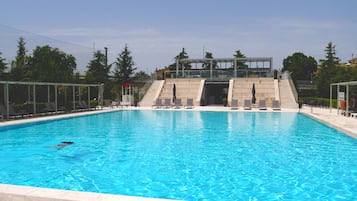 Seasonal outdoor pool, open 9:00 AM to 7:00 PM, pool umbrellas