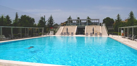 Seasonal outdoor pool, open 9:00 AM to 7:00 PM, pool umbrellas. Kairos Resort