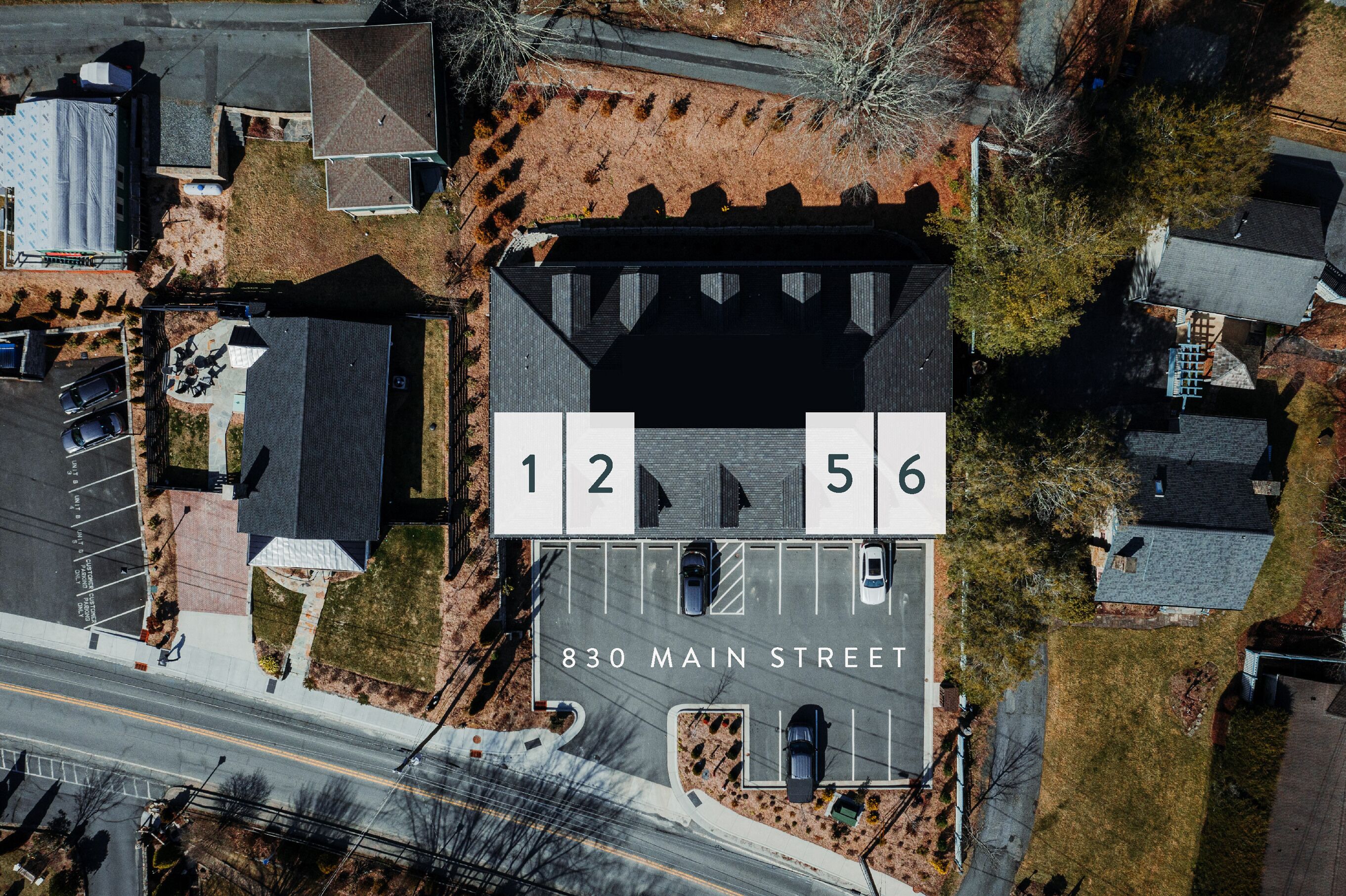An aerial view of a building with numbered parking spaces 12 and 56, located at 830 Main Street.
