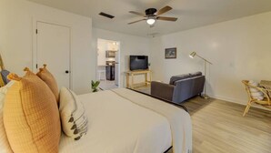 A bedroom with a bed, a television, a sofa, and a ceiling fan. - Quaint 1 BR Apt | Mins from ZOO, USC & FT Jackson (Columbia)