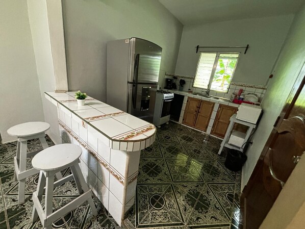 Een koffiezetapparaat/waterkoker, kookgerei, borden en bestek