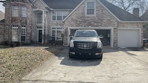 A two-story brick house with a garage and a driveway. - Home in South Tulsa (Tulsa)