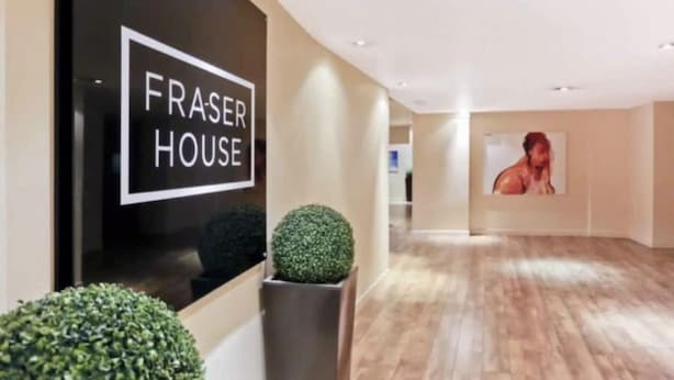 A modern interior with a sign reading "FRASER HOUSE".