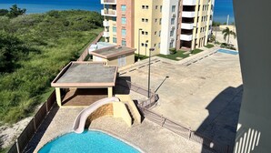 A multi-story hotel with a swimming pool, a slide, and a view of the ocean. - Unique and Private Panoramic Ocean View Penthouse in Cabo Rojo, Puerto Rico (Cabo Rojo)