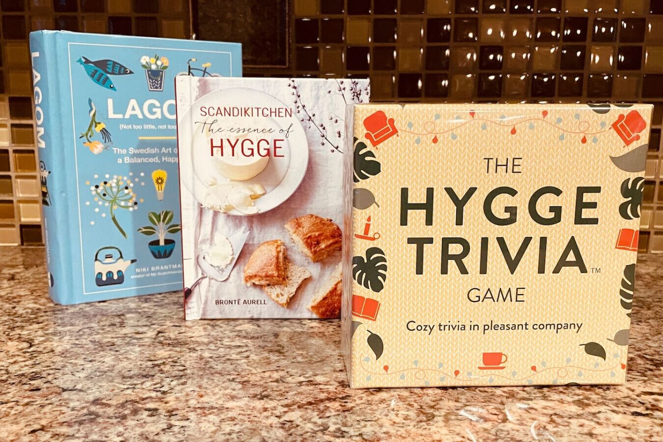 Three books on a kitchen counter.