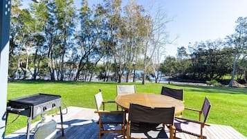 Enjoy al fresco dining on the deck overlooking the water, with a barbecue grill and comfortable seating for six.