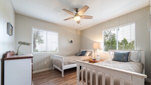 A bedroom with two single beds, a ceiling fan, and a dresser. - Hillside Paradise near Hidden Falls! Clean 3/1.5, Expansive views (Marble Falls)