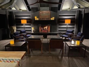 A cozy lounge area with a fireplace, seating, and a decorative wall. - SkyFall - Views, Views, Views! Blowing Rock Home (Blowing Rock)