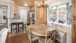 A kitchen with wooden cabinets, a built-in stove, and a large window. - Bearway to Heaven - 2BR/2BA Condo, Downtown BR (Blowing Rock)