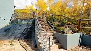 A staircase leading up to a building with a metal railing and a wooden fence. - Exquisite pet friendly home, 5 blks from Gondola with stunning views!! (Aspen)