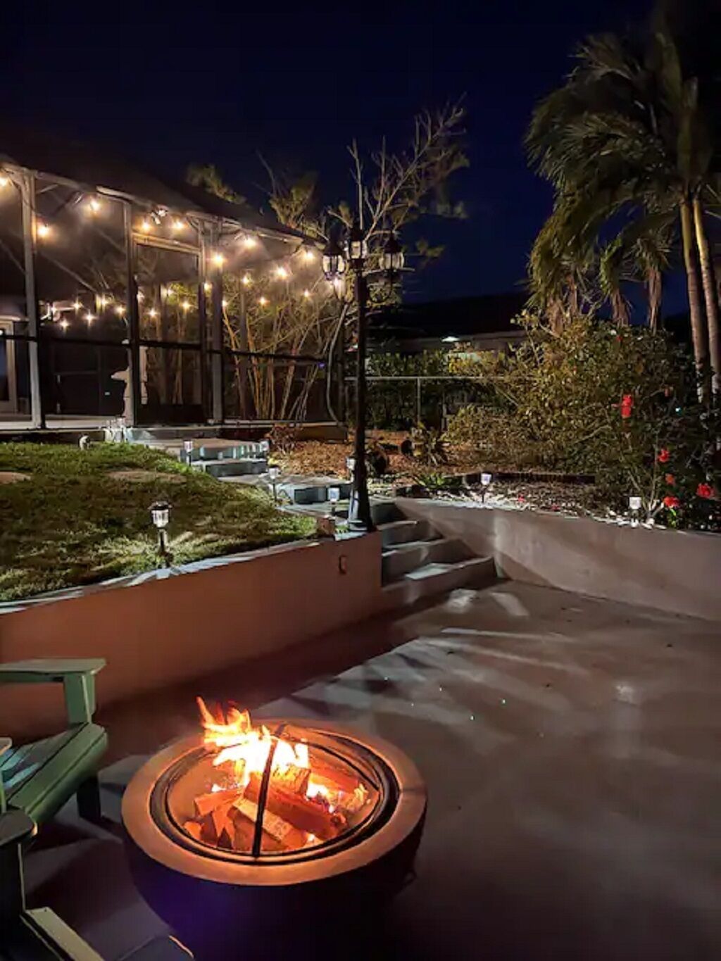 A fire pit in a landscaped outdoor area with a building in the background.