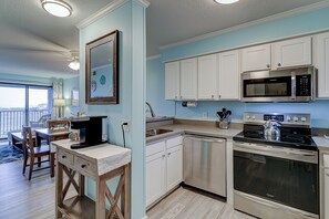 Enjoy meals in the kitchen with a dining area and large window offering a view of the outdoors.