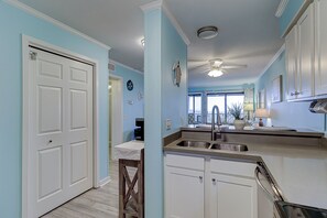 Enjoy cooking in this well-equipped kitchen with an oven, stainless steel sink, and ample natural light.