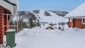 A snowy mountain landscape with cabins and a ski lift in the background. - Alppi 6b paritalo by Interhome (Hyrynsalmi)