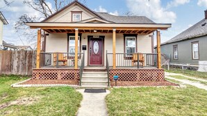 A two-story house with a front porch, a red door, and a mailbox. - 💎Urban Glam Gem💎 Rancher near Gonzaga w/GiG Internet (Spokane)