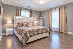 A bedroom with a large bed, bedside tables, a mirror, and curtains. - 💎Urban Glam Gem💎 Rancher near Gonzaga w/GiG Internet (Spokane)