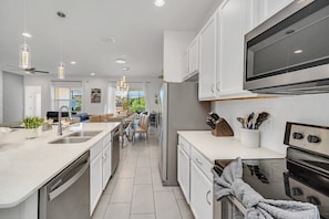 Enjoy cooking in the well-equipped kitchen with a central island, sink, and oven.