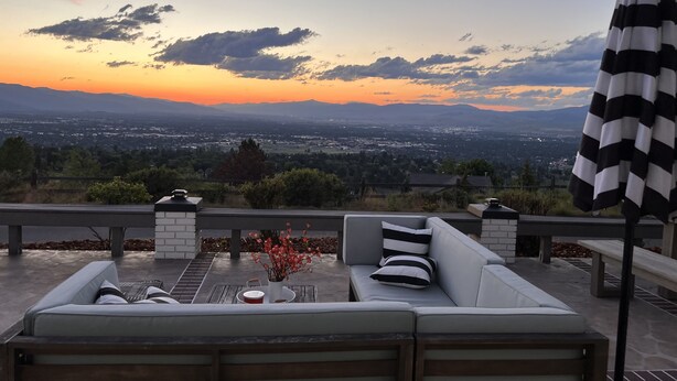 An outdoor seating area with a view of a cityscape at sunset. - 🏔Views for Days! Welcome to the Missoula Lookout! 🏔  (Missoula)