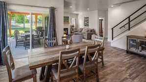 A spacious living area with a wooden dining table and chairs, a sofa, and a staircase. - Family Home | Marina, Dover Bay | Extended Stays (Dover)