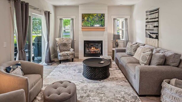 A living room with a fireplace, a sofa, a chair, and a coffee table. - Family Home | Marina, Dover Bay | Extended Stays (Dover)