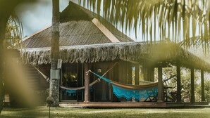 A thatched-roof building with a hammock in front. - Private garden bungalow just 200m from the beach (Fare)